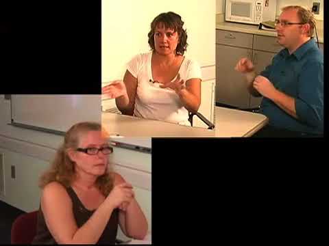 Split screen video. IN lower left, a white woman with glasses wearing a sleeveless brown blouse. In upper right, a white woman with brown hair sits at table with a white man who has blond hair, glasses, and is wearing an aqua button-down shirt with sleeves rolled up to elbow.
