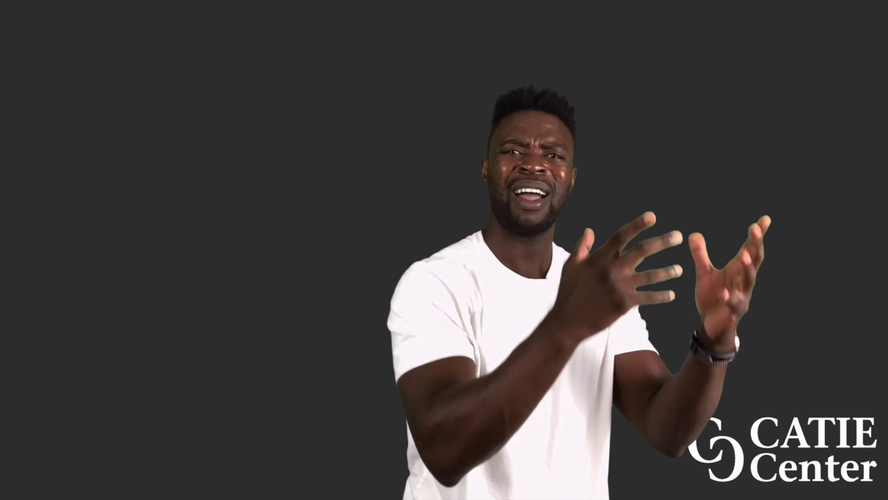 A Black man with a flattop haircut wears a white short-sleeve t-shirt and stands in front of a dark grey background. He narrates the entire story.  In the lower right corner of the video screen is a white CATIE Center logo.