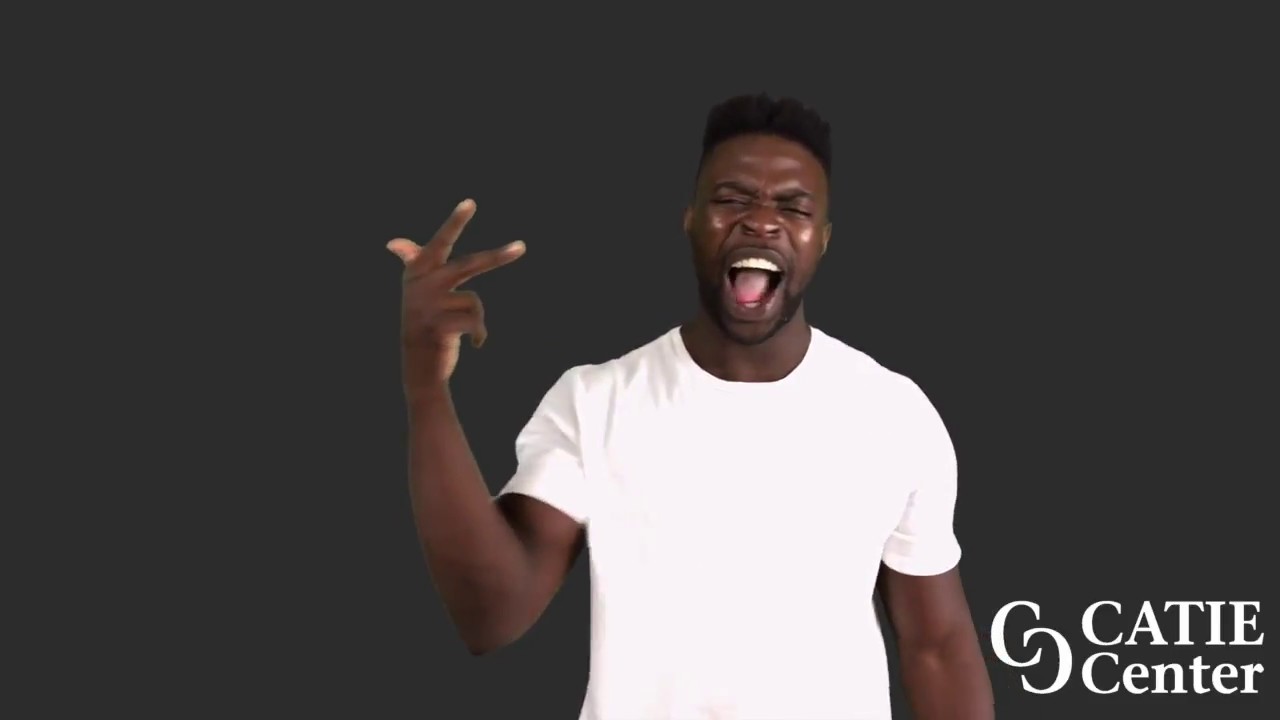 A Black man with a flattop wears a white short-sleeve t-shirt and stands in front of a dark grey background. He narrates the entire story.  In the lower right corner of the video screen is a white CATIE Center logo.