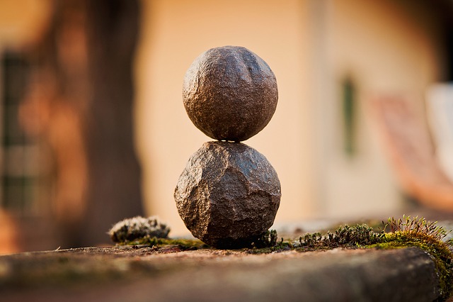 Two brown round rocks stacked on top of each other