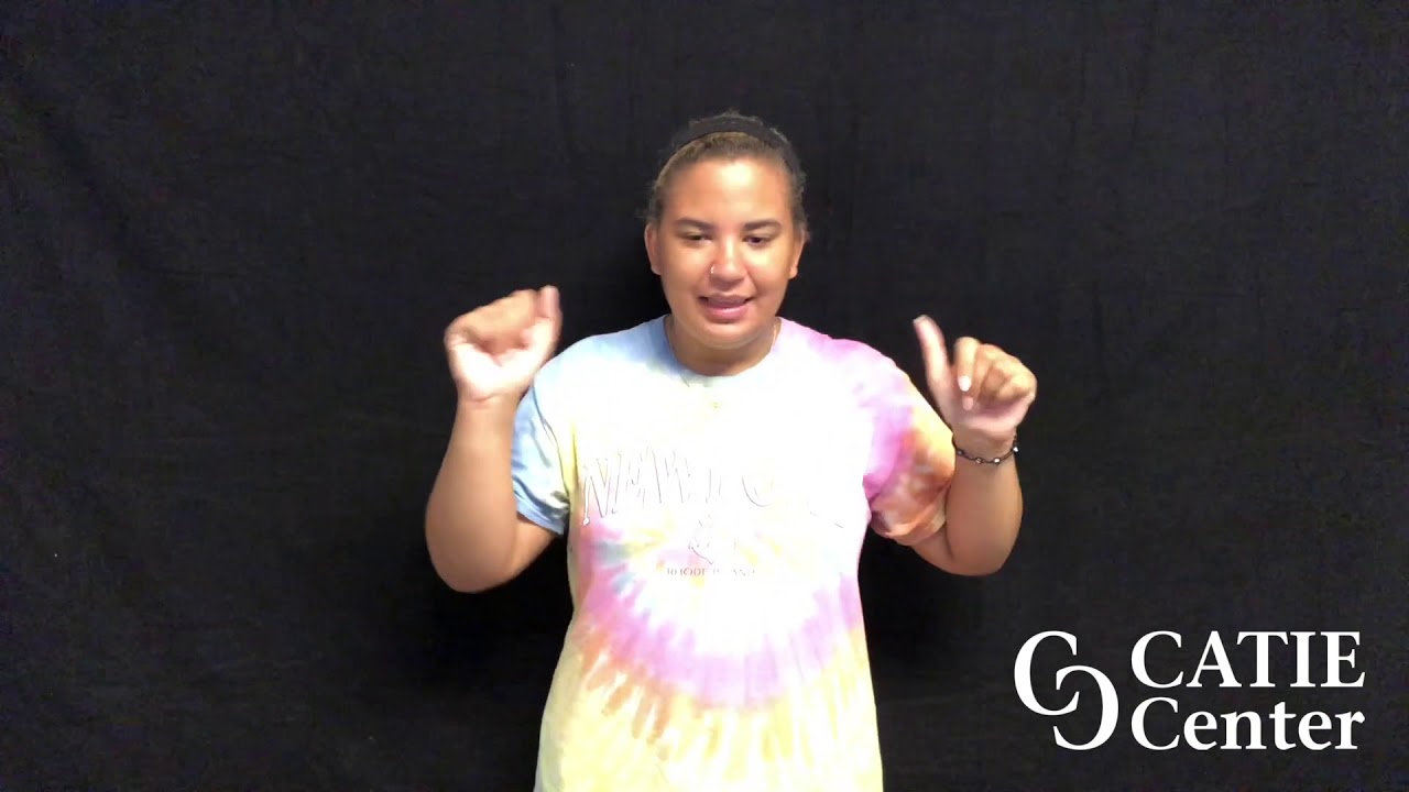Light skinned woman wearing colored dye short-sleeve shirt that has Newport printed on it and is shown from the waist up. She is standing in front of a dark-grey screen. A white CATIE Center logo is in the lower right corner of the screen.