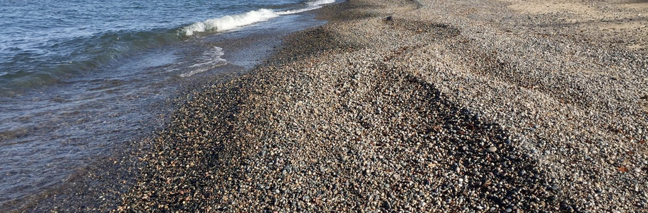 waters of Lake Superior lapping onto a rock beach